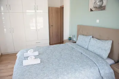 a bedroom with a bed with towels on it at Cozy flat 5min to subway station (EPIDAMN) in Athens
