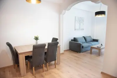 a dining room with a table and chairs and a couch at Cozy flat 5min to subway station (EPIDAMN) in Athens