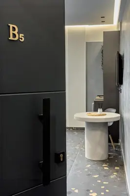 a table in an office with a black wall at Furla Suites Athens in Athens