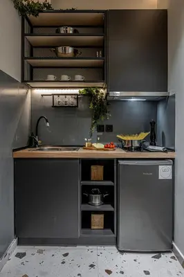 a kitchen with a sink and a counter top at Furla Suites Athens in Athens