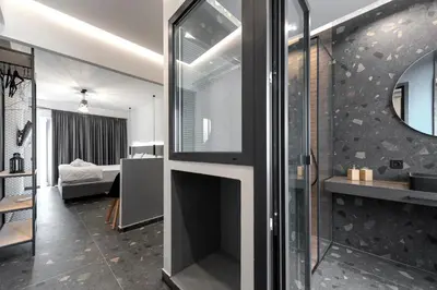 a fireplace in the middle of a living room at Furla Suites Athens in Athens