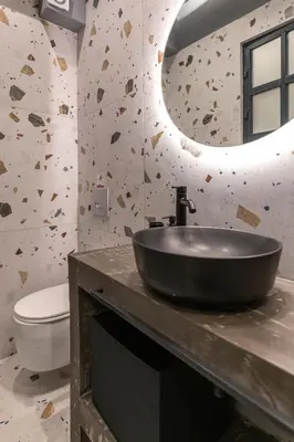a bathroom with a black sink and a mirror at Furla Suites Athens in Athens