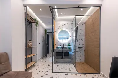 a hallway with a glass door leading into a room at Furla Suites Athens in Athens