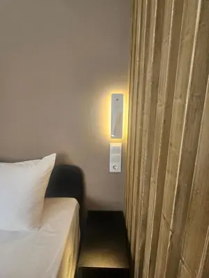 a hotel room with a bed and a curtain at Sun Marco Apartments in Athens in Athens