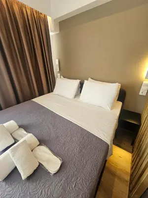 a bedroom with a large bed with white pillows at Sun Marco Apartments in Athens in Athens