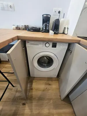 a washer and dryer under a counter in a kitchen at Sun Marco Apartments in Athens in Athens