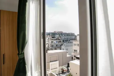a window with a view of a city at Sun Marco Apartments in Athens in Athens