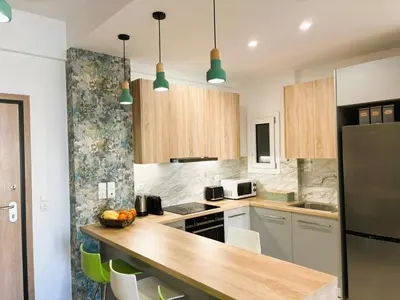 a kitchen with a counter top and a refrigerator at Apartament Athina in Athens