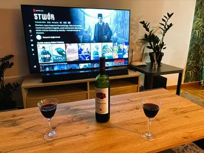 a bottle of wine and two glasses on a table at Apartament Athina in Athens