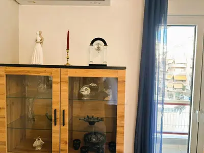 a wooden cabinet with a clock on top of it at Apartament Athina in Athens