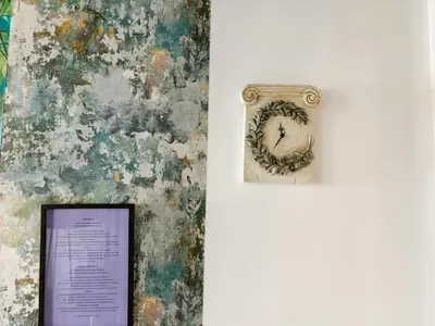 a picture frame on a wall next to a painting at Apartament Athina in Athens