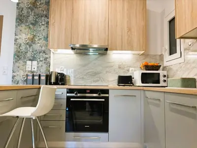 a kitchen with a stove and a microwave at Apartament Athina in Athens