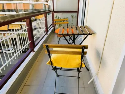 a balcony with a table and a chair on it at Apartament Athina in Athens