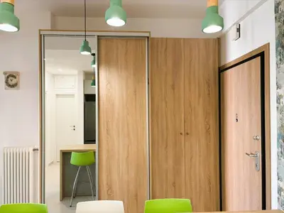 a room with a sliding door and green chairs at Apartament Athina in Athens