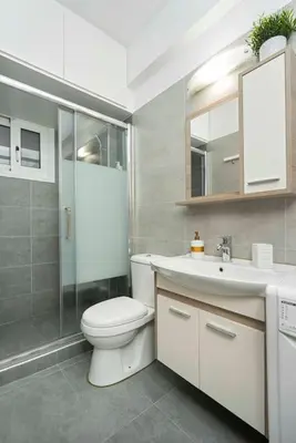 a bathroom with a toilet and a sink and a shower at Filoxenia MG Projects city center in Athens