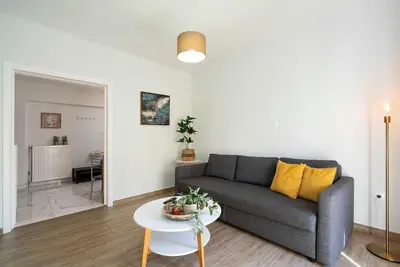 a living room with a couch and a table at Filoxenia MG Projects city center in Athens