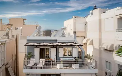 a balcony with chairs on a building at Jacuzzi Luxpenthouse PFaliro in Athens