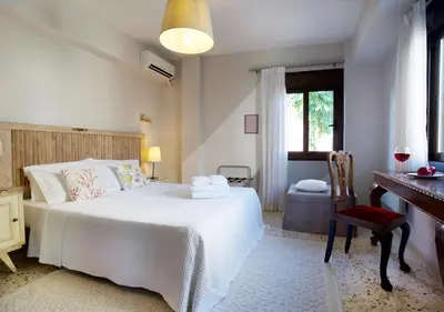 a bedroom with a bed and a desk and a window at Live in Athens, PSYRRI Meet Me Here Apartments in Athens