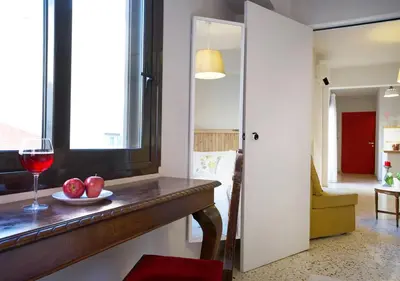 a room with a table with a glass of wine at Live in Athens, PSYRRI Meet Me Here Apartments in Athens