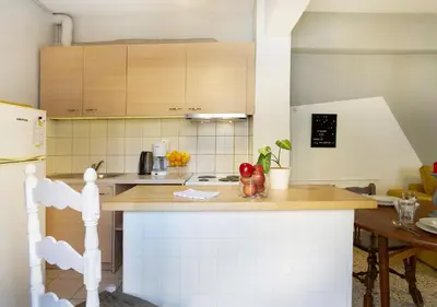 a kitchen with a counter top and a refrigerator at Live in Athens, PSYRRI Meet Me Here Apartments in Athens