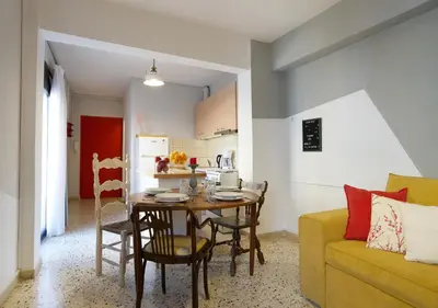 a kitchen and dining room with a table and a couch at Live in Athens, PSYRRI Meet Me Here Apartments in Athens
