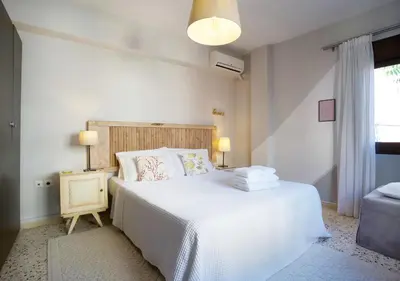 a bedroom with a large white bed and a window at Live in Athens, PSYRRI Meet Me Here Apartments in Athens