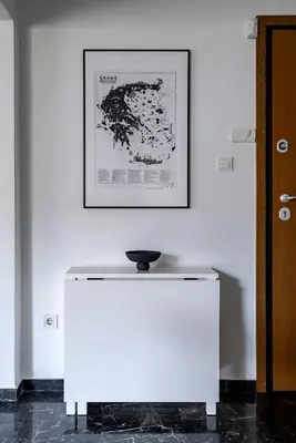 a white table in a room with a picture on the wall at The Black Marble - Sea View, 2BR, 2BA in Paleo Faliro in Athens