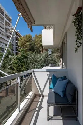 a balcony with a bench and a sink at The Black Marble - Sea View, 2BR, 2BA in Paleo Faliro in Athens