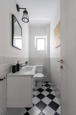 a white bathroom with a sink and a toilet at The Black Marble - Sea View, 2BR, 2BA in Paleo Faliro in Athens