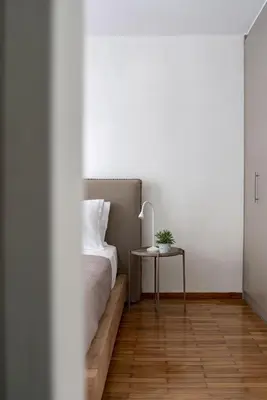 a bedroom with a bed and a side table at The Black Marble - Sea View, 2BR, 2BA in Paleo Faliro in Athens
