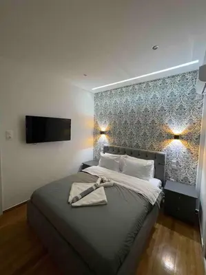 a bedroom with a bed with a towel on it at ATH Luxury Central apartment in Athens
