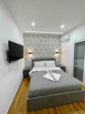 a bedroom with a large bed with a towel on it at ATH Luxury Central apartment in Athens