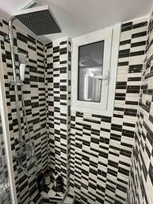 a bathroom with a shower and a window on a wall at ATH Luxury Central apartment in Athens
