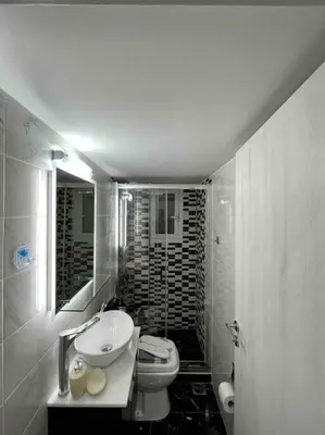 a white bathroom with a sink and a toilet at ATH Luxury Central apartment in Athens