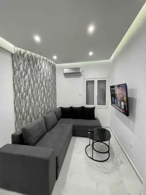 a living room with a couch and a table at ATH Luxury Central apartment in Athens