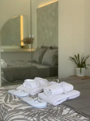 a pile of towels sitting on top of a bed at Luxury Athens Apartment with Breathtaking Views in Athens
