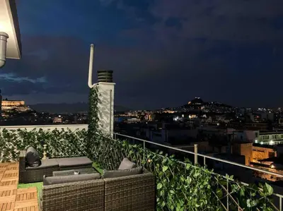 a balcony with a view of a city at night at Luxury Athens Apartment with Breathtaking Views in Athens