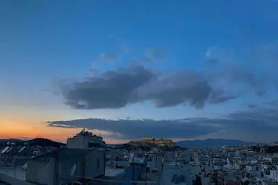 a view of a city at sunset at Luxury Athens Apartment with Breathtaking Views in Athens