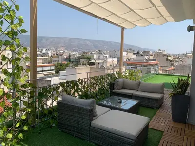 a balcony with couches and a view of a city at Luxury Athens Apartment with Breathtaking Views in Athens