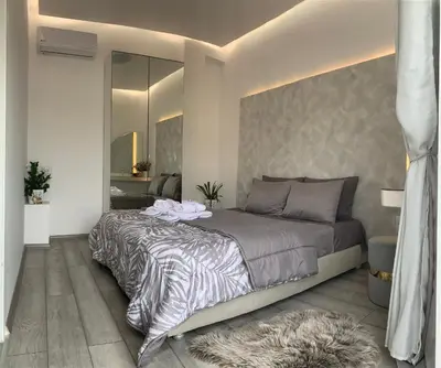 a bedroom with a large bed and a mirror at Luxury Athens Apartment with Breathtaking Views in Athens