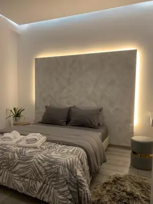 a bedroom with a bed with a large headboard at Luxury Athens Apartment with Breathtaking Views in Athens