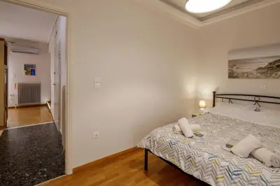 a bedroom with a bed with two pillows on it at City view roof top apt 10min from Acropolis museum in Athens
