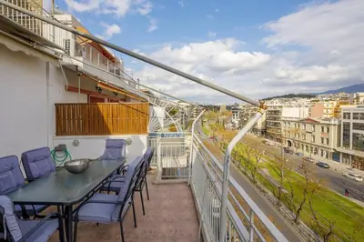 a balcony with a table and chairs on a building at City view roof top apt 10min from Acropolis museum in Athens