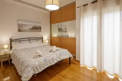 a bedroom with a bed with two pillows on it at City view roof top apt 10min from Acropolis museum in Athens