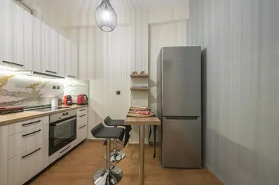 a kitchen with a refrigerator and a table in it at Athens center spacious apartment in Athens