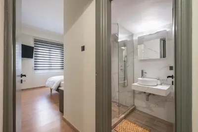 a bathroom with a sink and a mirror at Athens center spacious apartment in Athens