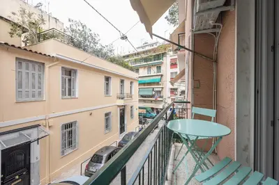 a balcony with a table and chairs and buildings at Athens center spacious apartment in Athens