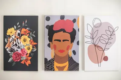 three paintings of a woman with flowers on them at Athens center spacious apartment in Athens