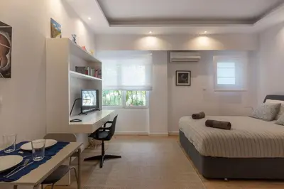 a bedroom with a bed and a desk with a computer at Brand new apartment in Athens in Athens
