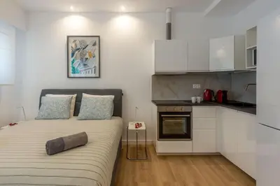 a small bedroom with a bed and a kitchen at Brand new apartment in Athens in Athens
